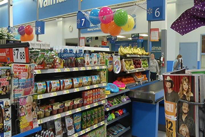 Walmart checkout, with healthy foods, fruits, and frisbees displayed where candy and chocolate is normally