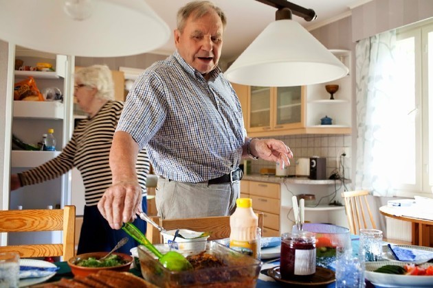 Mauno Lempinen, a woodcutter in his 90s, serving lunch with his wife Helka