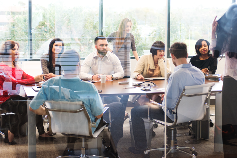 Group of people discussing something around a table