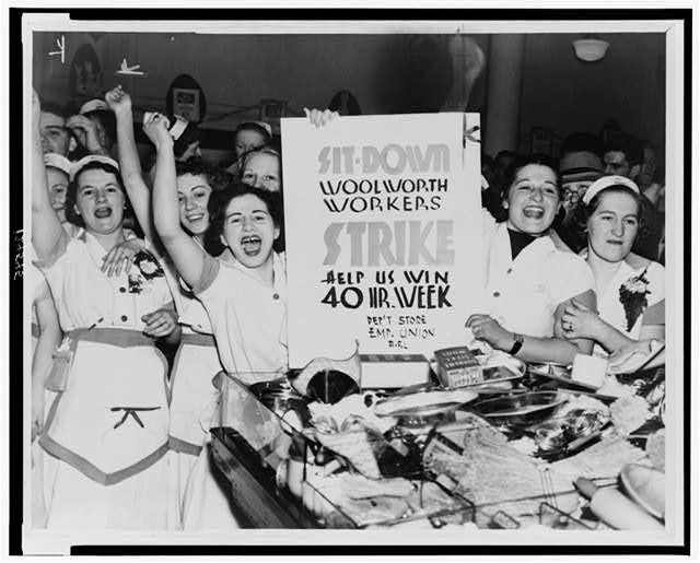 Female employees of Woolworth's holding sign indicating they are striking for a 40 hour work week